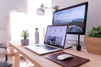 Home Office Laptop Open Monitor Behind Lamp Light Filled Room